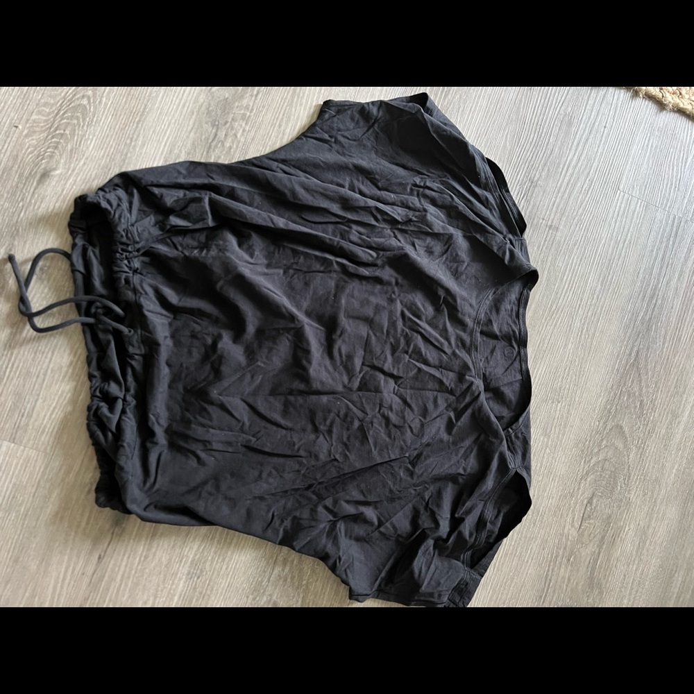 Black Lululemon shirt with a tie and slits in the shoulder